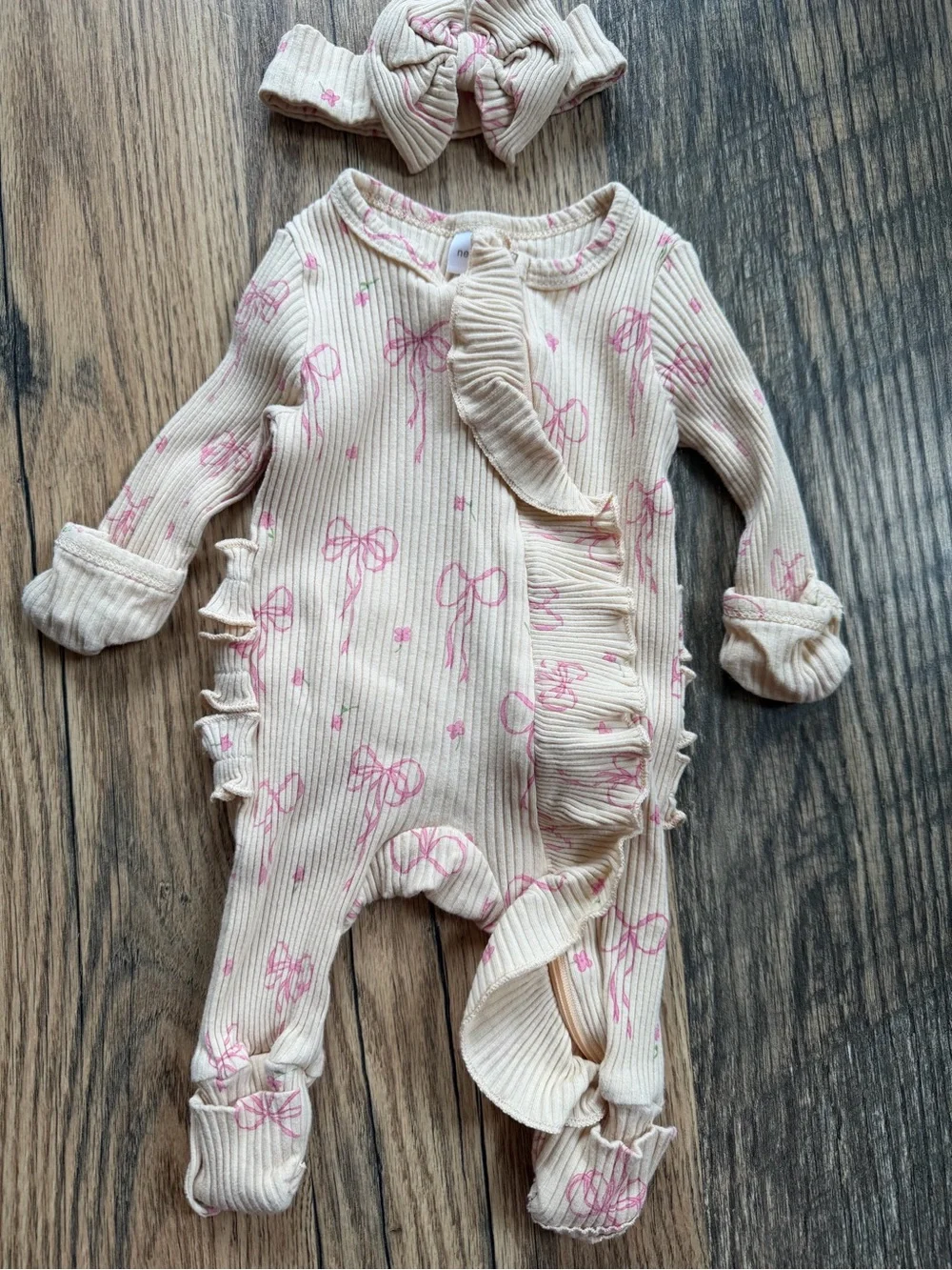 Neutral Cream Ribbed One-Piece with Pink Bow Print and Ruffle Trim and Headband